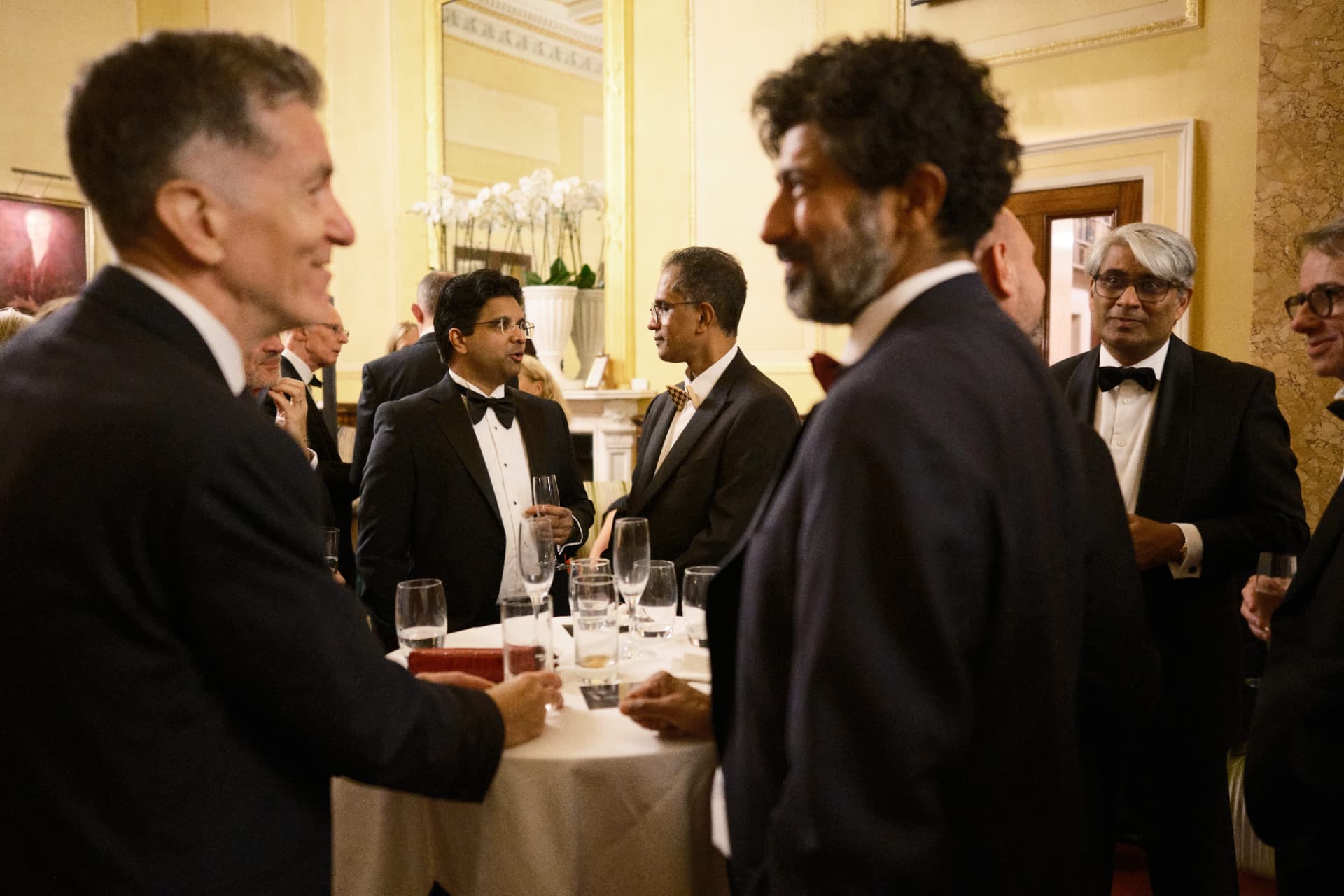 Guests in conversation around a cocktail table at The Room: Robotic Surgery